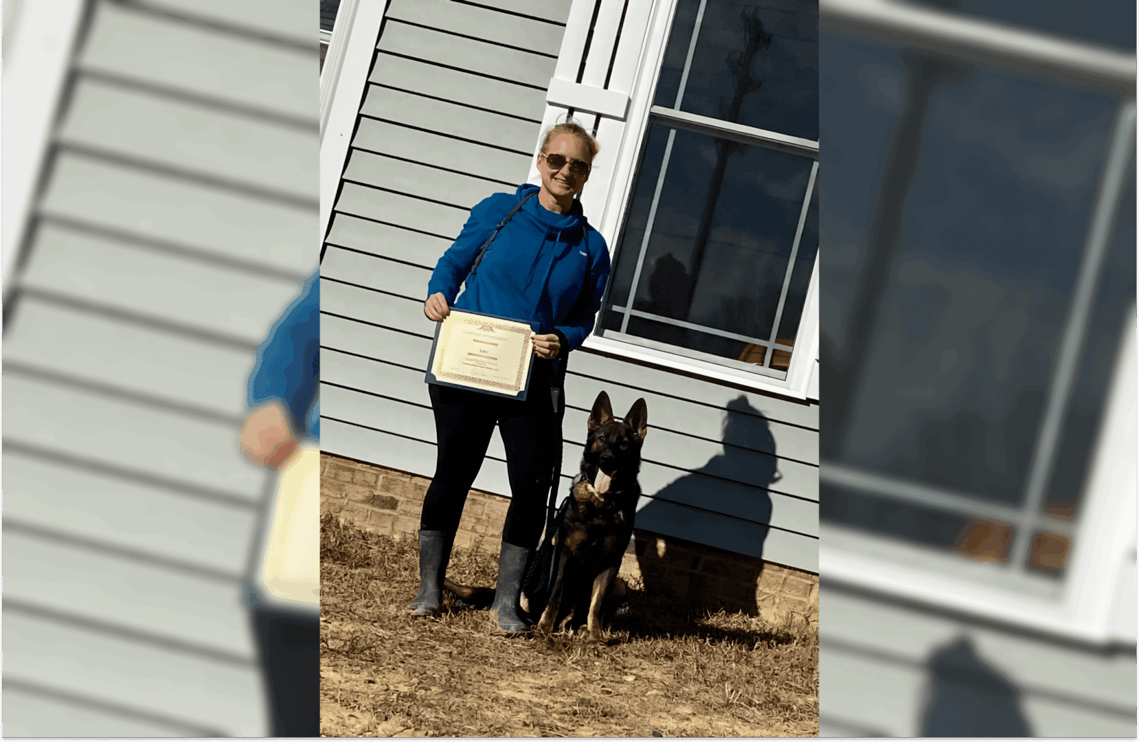 A woman and her dog standing in front of a house.