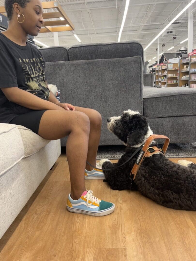A person sitting on the couch with their dog
